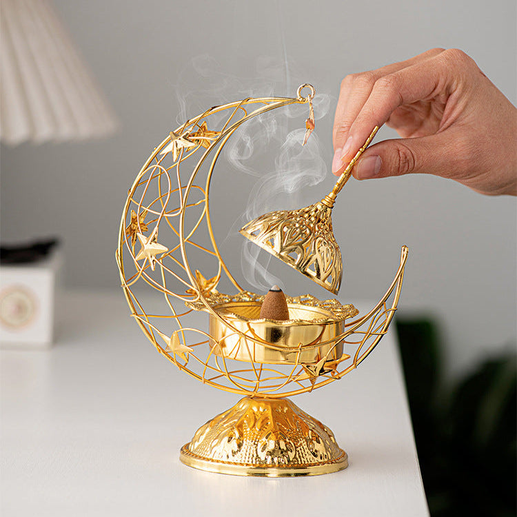 A Person is opening the lid of Ramadan Crescent Bukhoor Burner with Burning Incence.