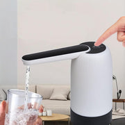 A Person is Pressing the Button Of Rechargeable Electric Water Dispenser Pump and Collecting Water.