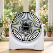 Rechargeable USB Desktop Fan with black center on a wooden surface, blurred greenery in the background