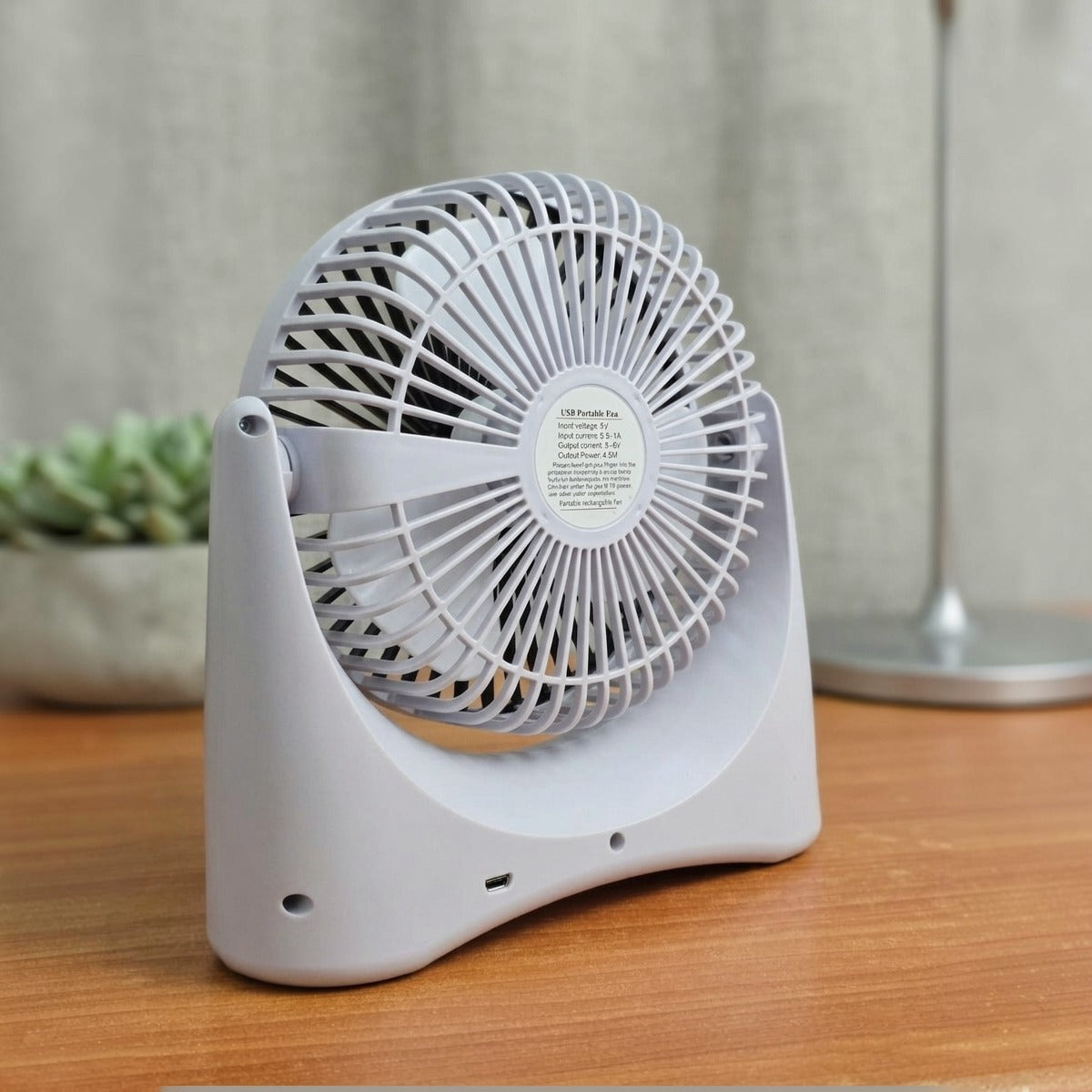Rechargeable USB Desktop Fan on a wooden surface with a blurred background