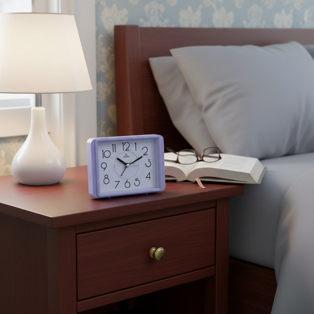 Rectangular alarm clock placed on a wooden side table in a modern bedroom.