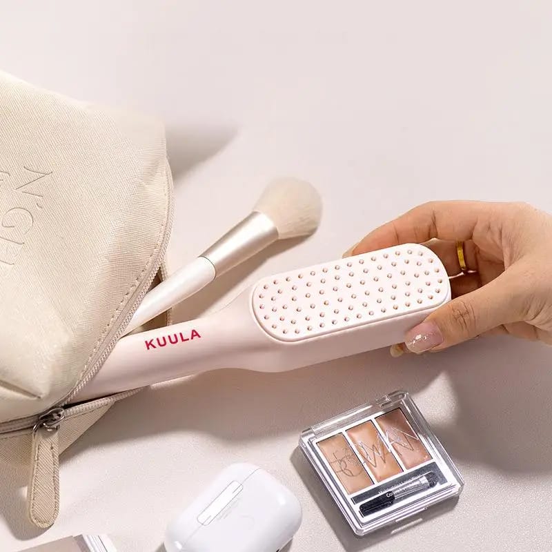 A Person is Taking Retractable Self Cleaning Hair Brush From Bag.