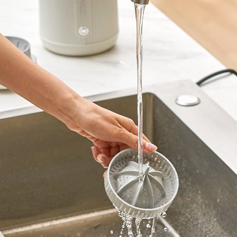 A Person is Cleaning Royadulex Electric Orange Fruit Juicer.