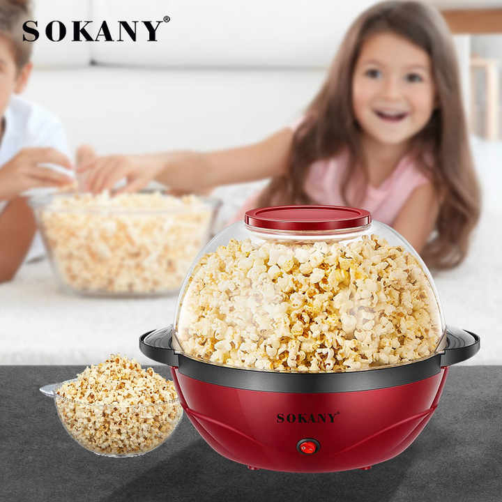 A Girl is Eating Popcorn Made Using Electric Popcorn Maker .