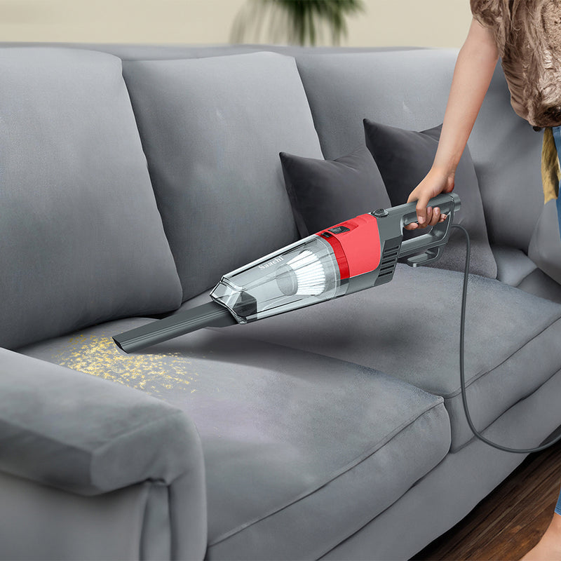 A Woman is Holding Saachi 2-in-1 Stick & Handheld Vacuum Cleaner.