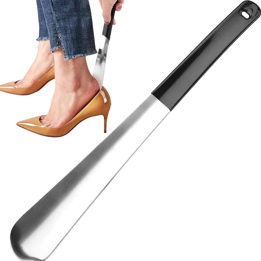 A Women is Pulling Her Shoe Using Shoe Horn.