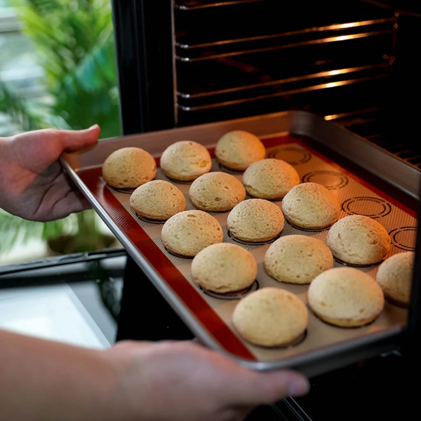 A Person is Placing Silicone Macron Baking Dough Mat with Macron in an Oven.