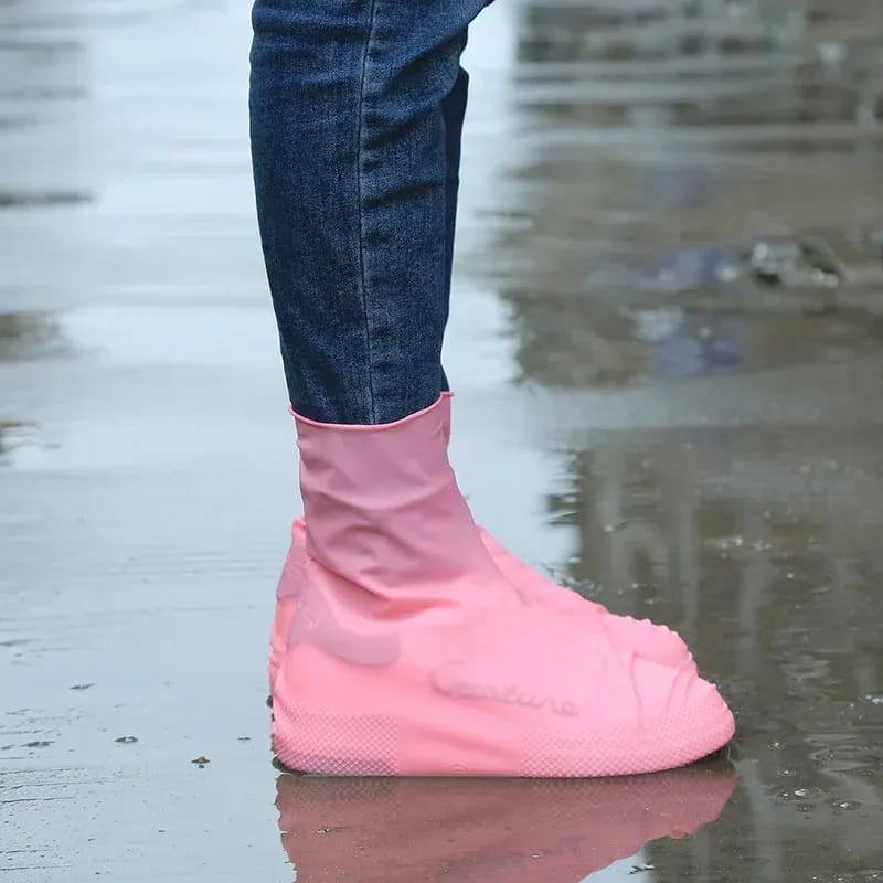 A Person is Protected his Shoe by Wearing Silicone Waterproof Shoe Cover.