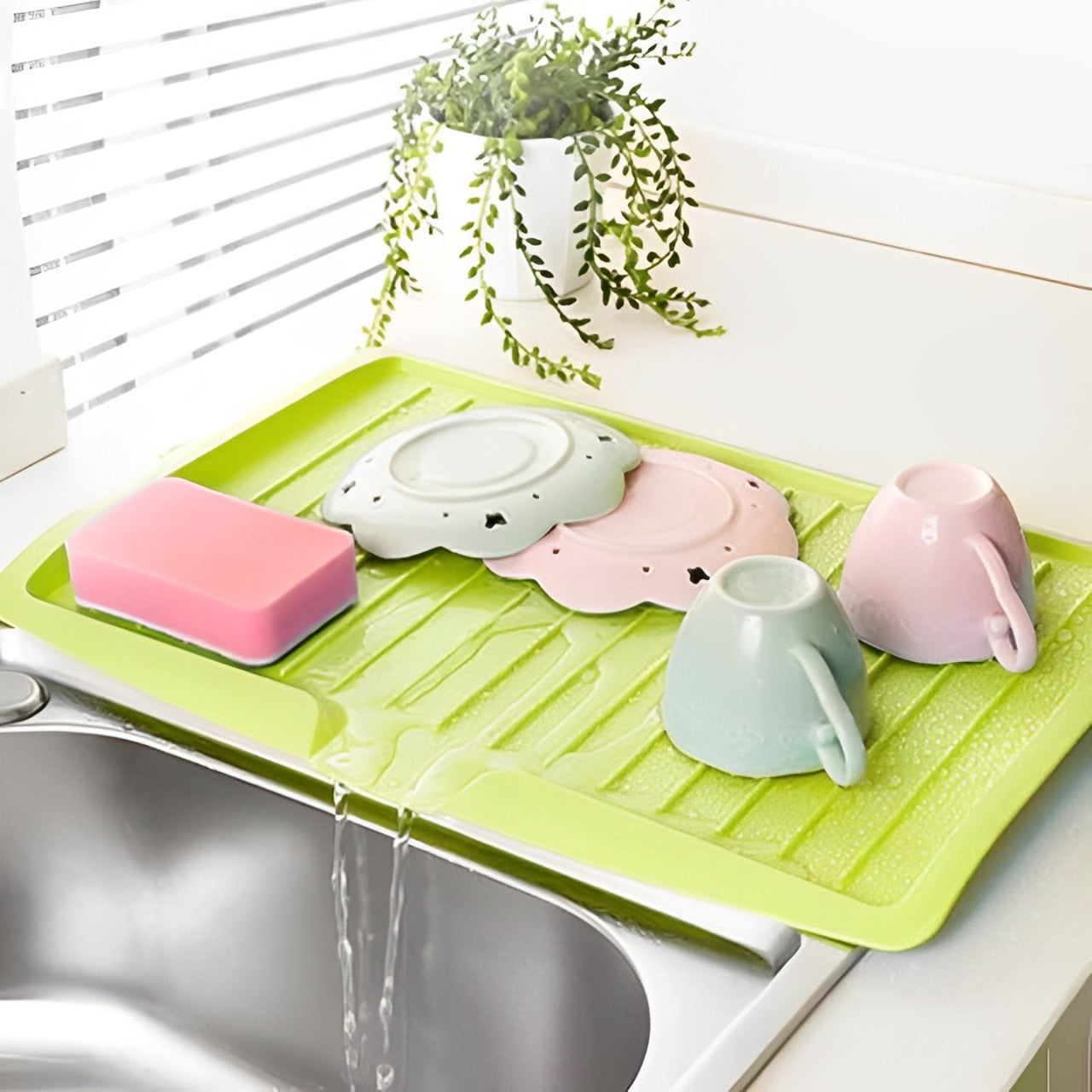 Utensils Are Placed On The Sink Dish Drainer Tray Rack.