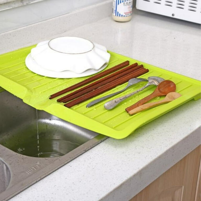 Utensils Are Placed On The Sink Dish Drainer Tray Rack.