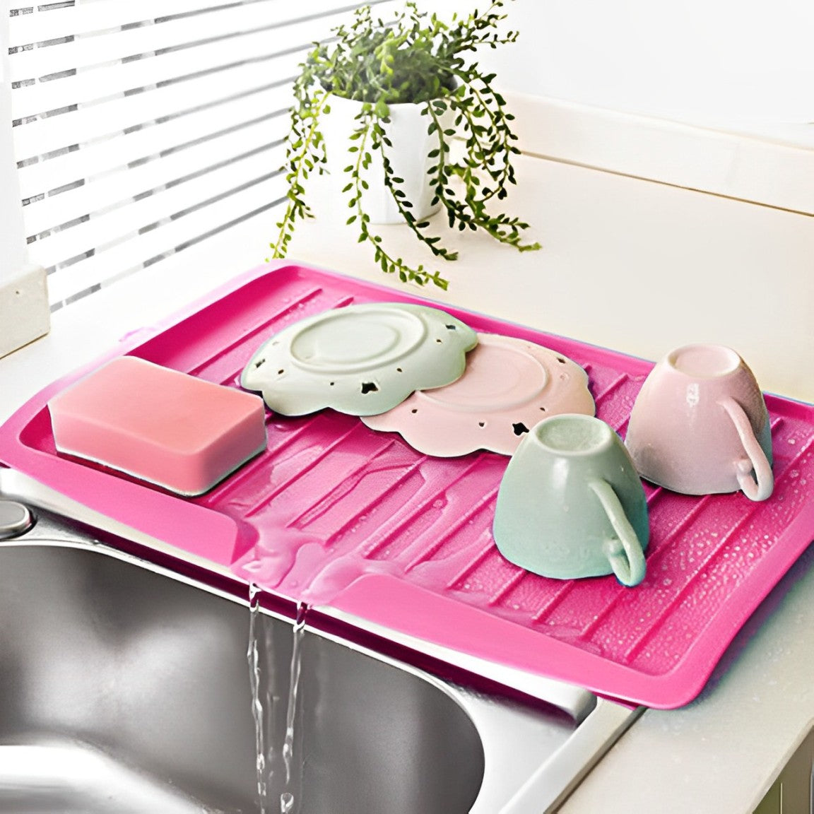 Utensils Are Placed On The Sink Dish Drainer Tray Rack.