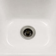 Close-up of a white kitchen sink with a Sink Drain Strainer 