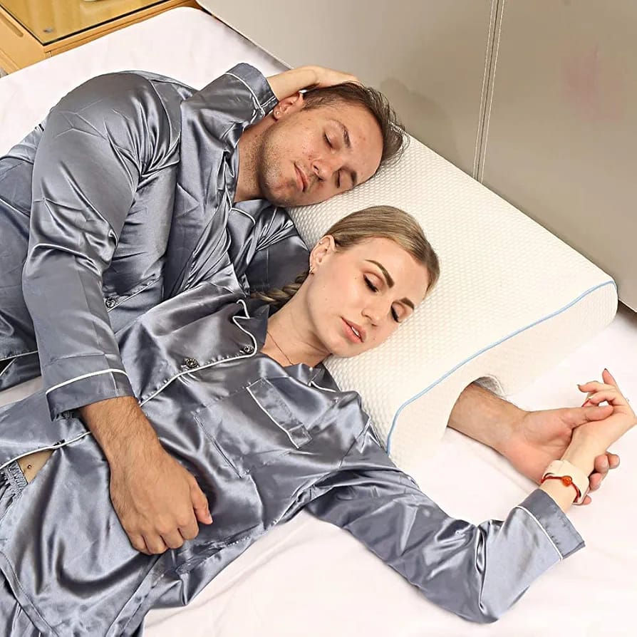 A Couple is Sleeping In a Arched Couple Cuddle Pillow.