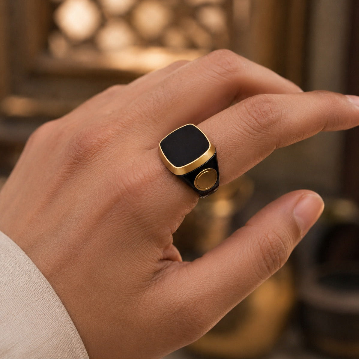 Hand wearing a Smart Tasbih Ring Counter with a blurred background