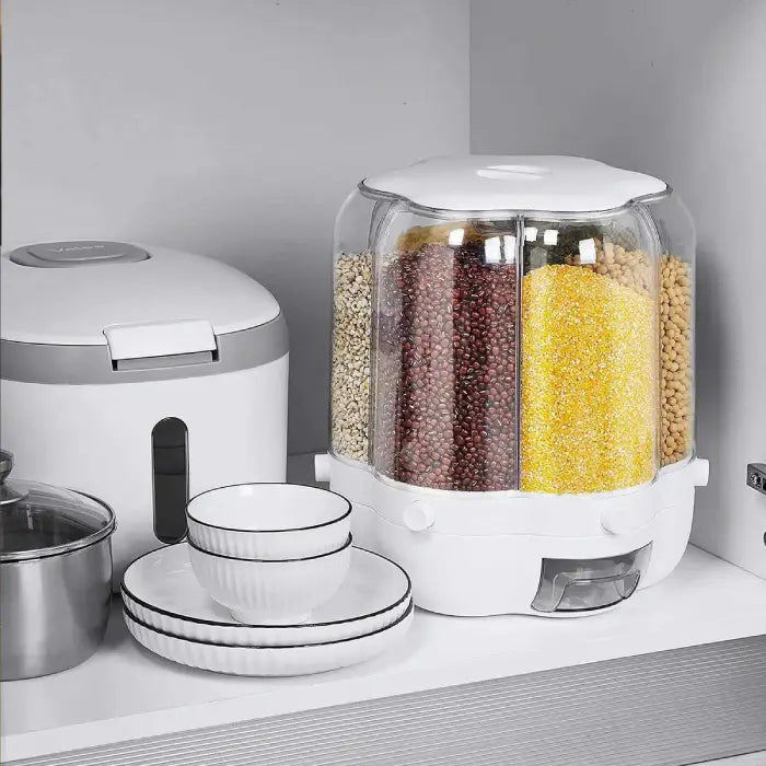 Kitchen setup with a rice cooker, bowls, and a transparent food storage container on a gray surface.