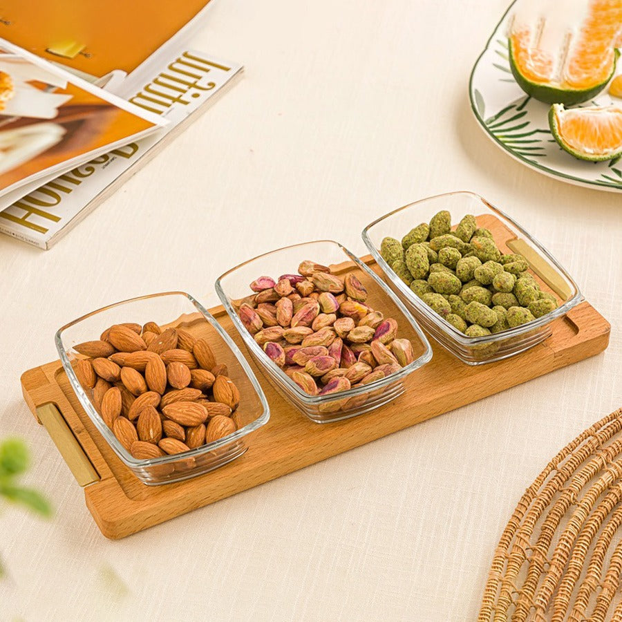 A Snack Serving 3-Section Glass Bowl with Wooden Base Tray  with Nuts.