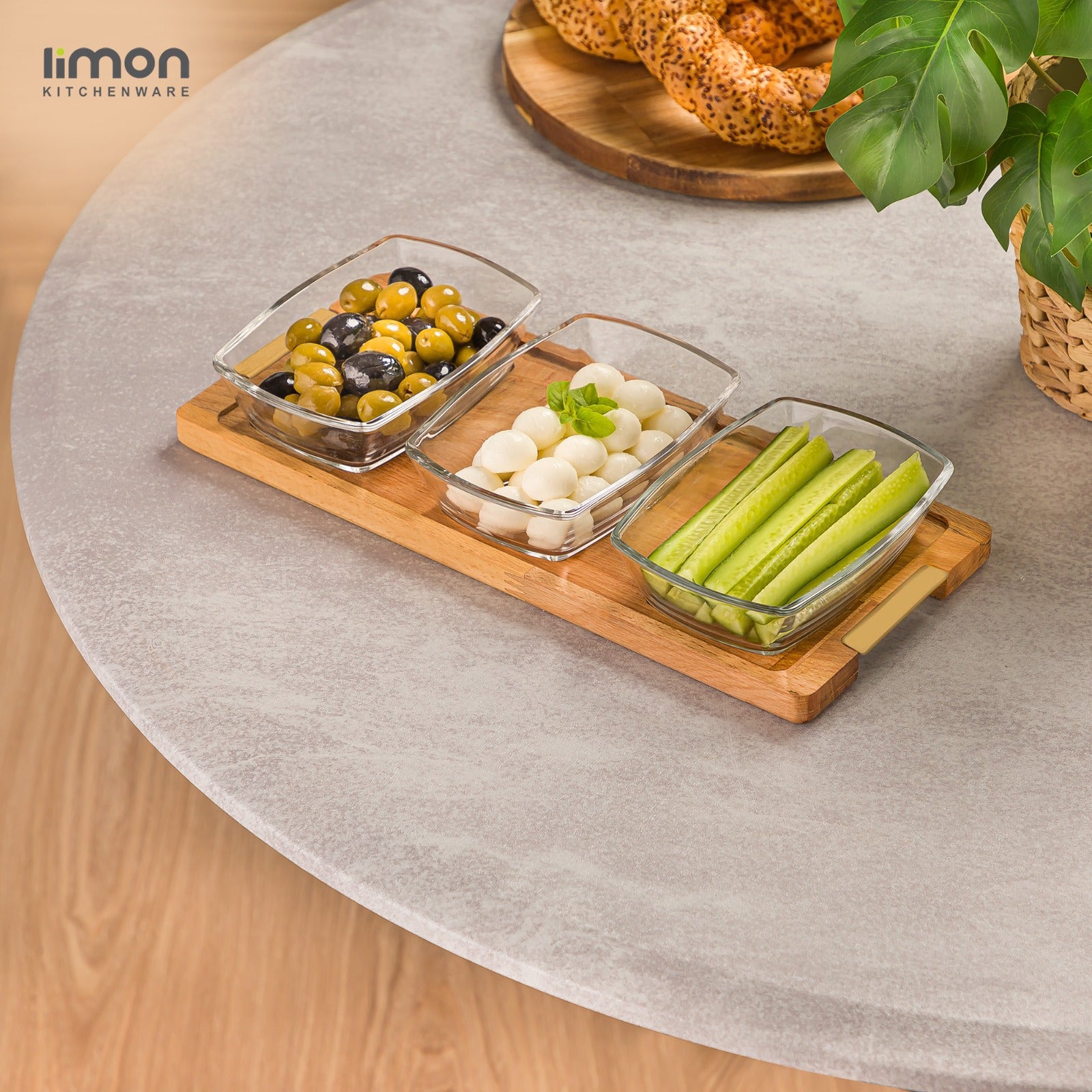 A Snack Serving 3-Section Glass Bowl with Wooden Base Tray with Food Items.