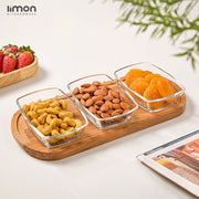 A Snack Serving Tray with Wooden Base Filled With Dry Fruits.