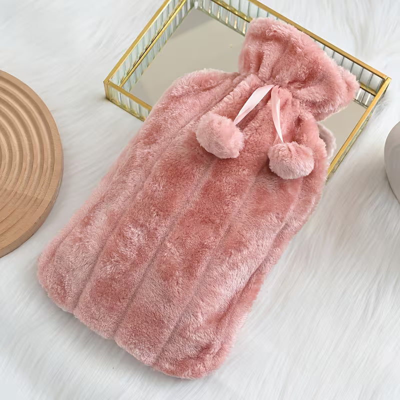 Soft Plush Hot Water Bag with pom-poms on a white surface.