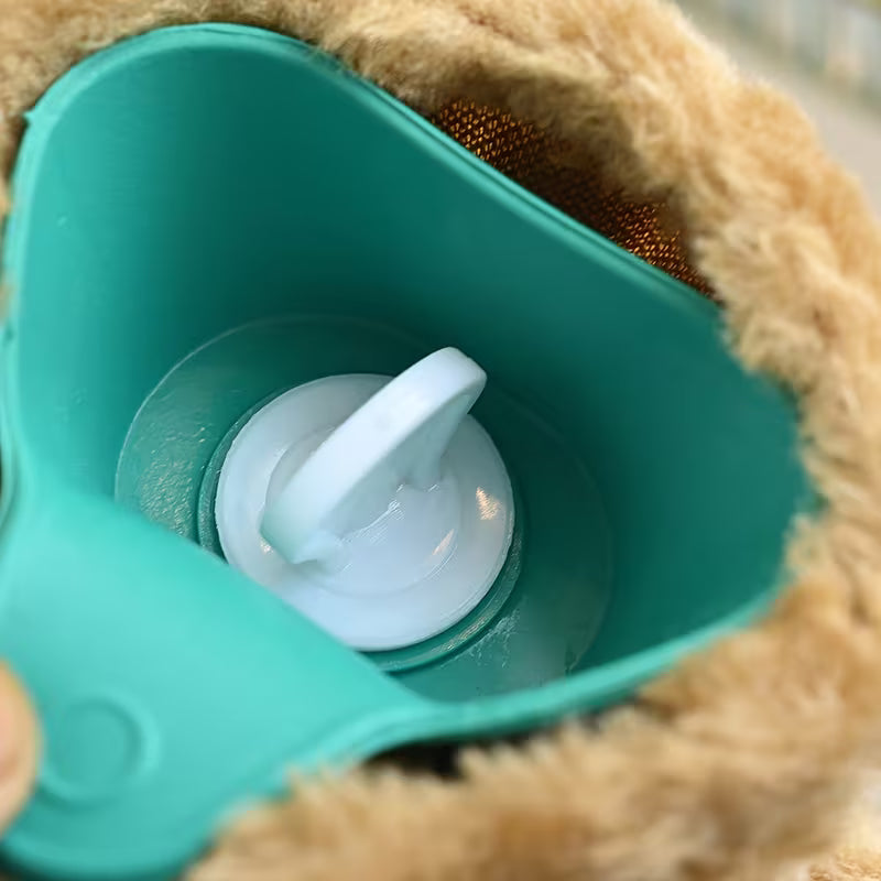 Close-up of a Soft Plush Hot Water Bag with a white cap inside a plush toy.