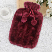 Soft Plush Hot Water Bag with Fleece Cover with pom-poms on a textured white surface.