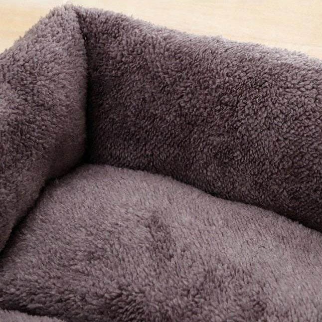 Close-up of a fluffy, dark gray Soft Plush Pet Bed