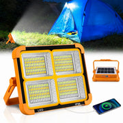 Solar Rechargeable LED Flood Light with a Background of Camping Setup.