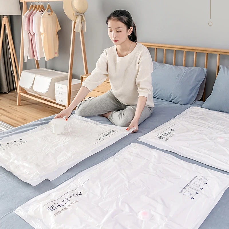 A Women is Compressing Space Saving Vacuum Seal Bags.