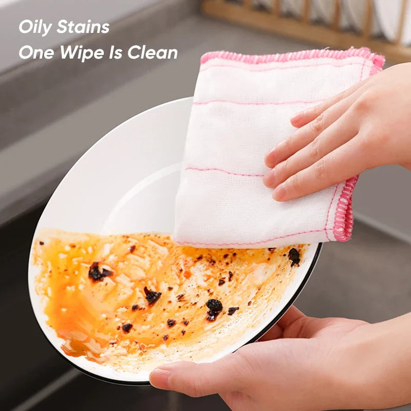 Someone is cleaning a plate with the help of a Kitchen Dishwashing Cloth