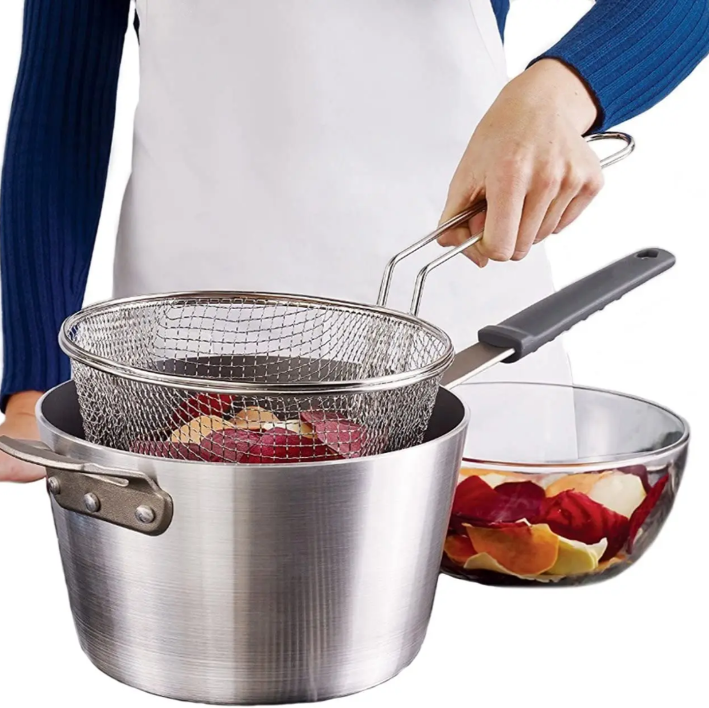 A person using a deep fry basket lifting chips from pot; safe folding handle grip