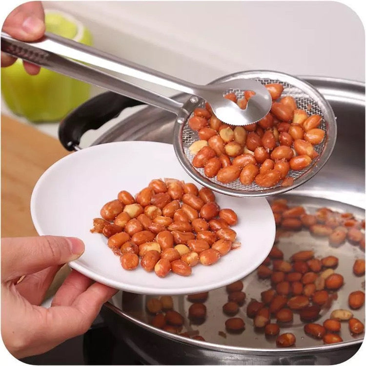 A Person is Straining Peanut From Oil Using Stainless Steel Strainer.