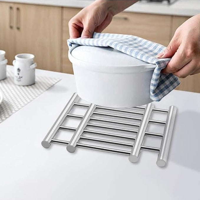 A Person is Placing Hot Container on Stainless Steel Trivet Pot Pad.