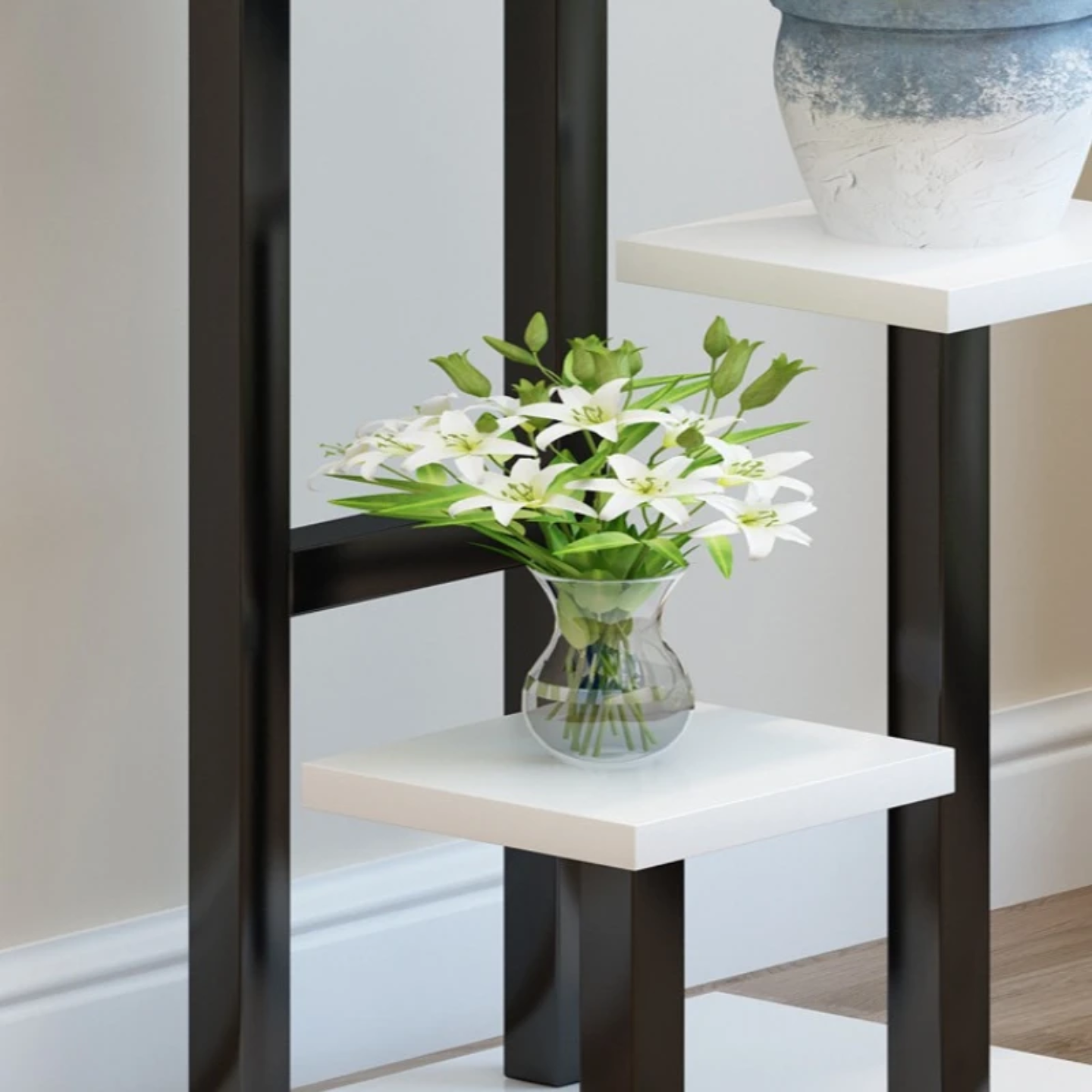 Stand of multi-tier indoor plant stand  displaying potted plant.