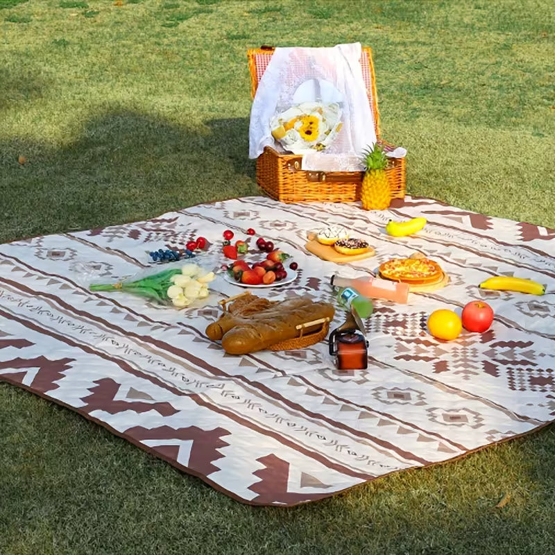 A Stylish Camping Mat is Placed in a Picnic area arranged with food items.