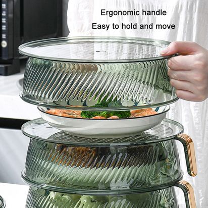 A person neatly arranges a stack of dishes on a counter, utilizing a space-saving storage rack