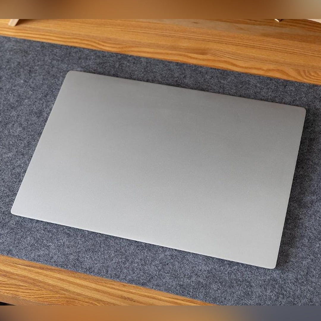 Table Mouse Pad in Grey Color Were Laptop Placed.