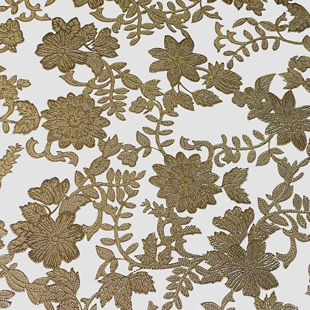Table Placemat of gold floral and leaf designs on a white background