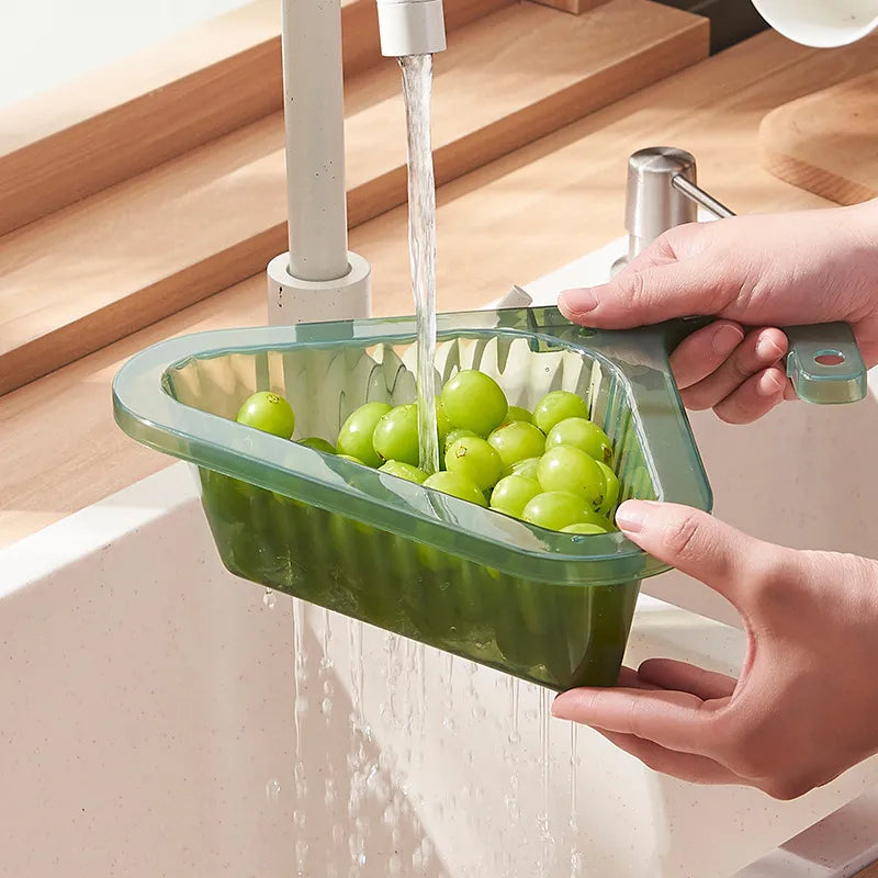 Someone cleaning grapes with Telescopic Sink Drain Basket
