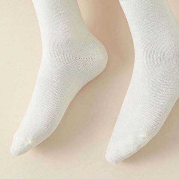 Someone wearing 1 Pair of Thick Winter Socks in white color