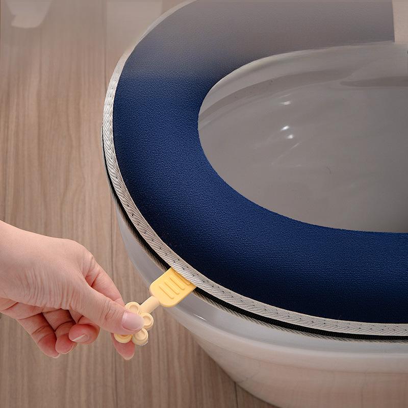 A person is pulling the handle of Toilet Seat Cover Cushion.