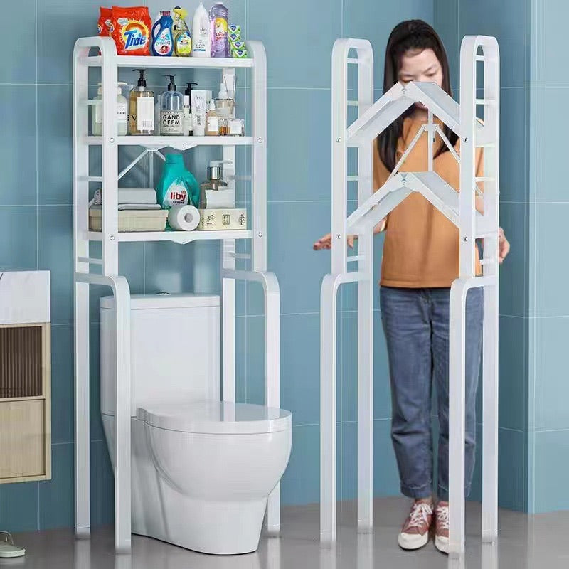 A Women is Fixing  Toilet Storage Rack and a Toilet Rack is Placed Beside Having Bathroom Essentials.