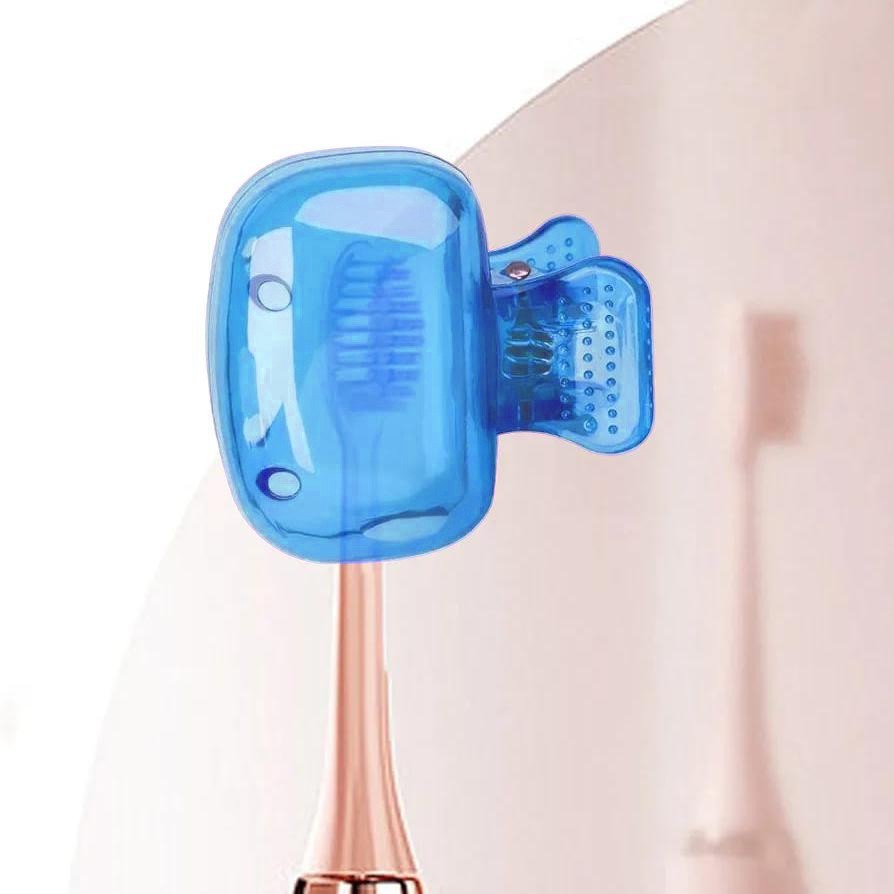 A brush holder clip attached to the neck of a toothbrush, shown against a soft beige background.