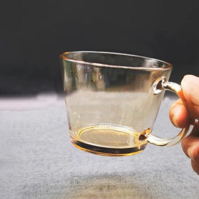 A Person is Holding Transparent V-Shaped Glass Cups