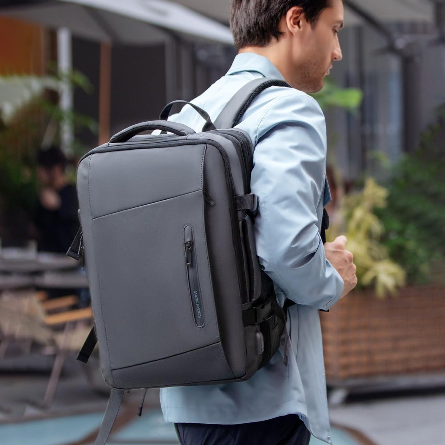 A Men is Carrying Travel Backpack.