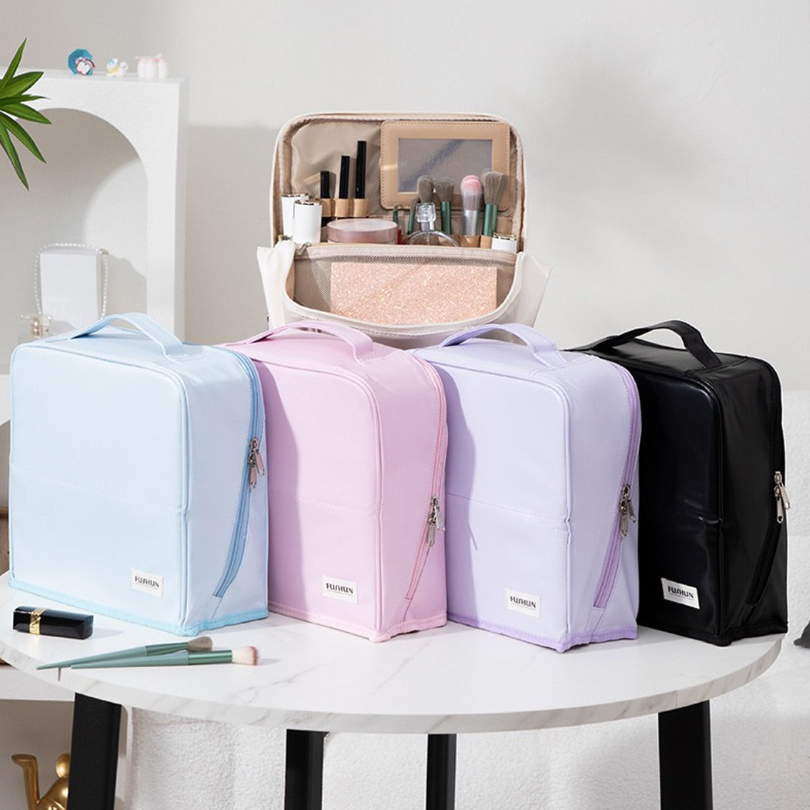 Four Travel Makeup Bag Cosmetic Organizer Case in pastel blue, pink, lavender, and black, with one open showing makeup organizers inside, displayed on a white table against a clean indoor background.