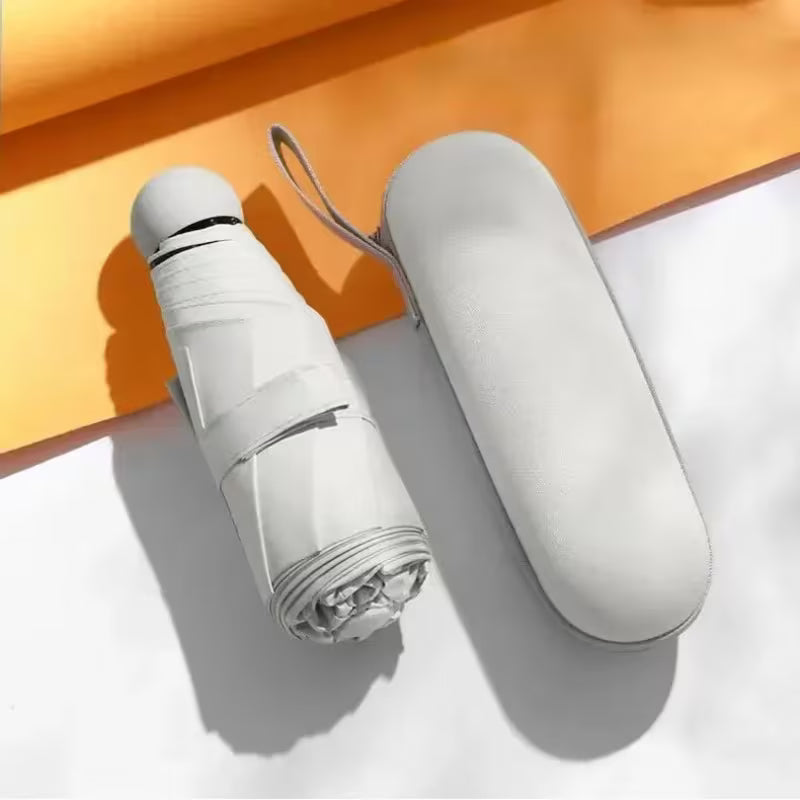White umbrella and its case on a white and orange background