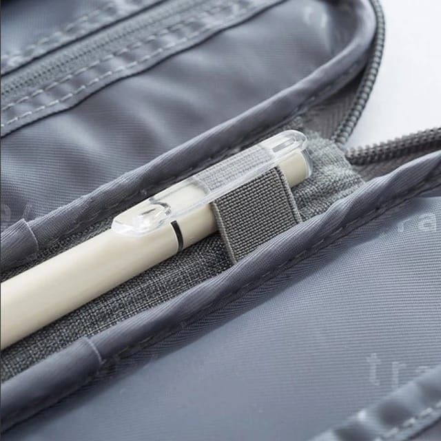 A pen placed in a Travel Passport and Document Organizer Bag