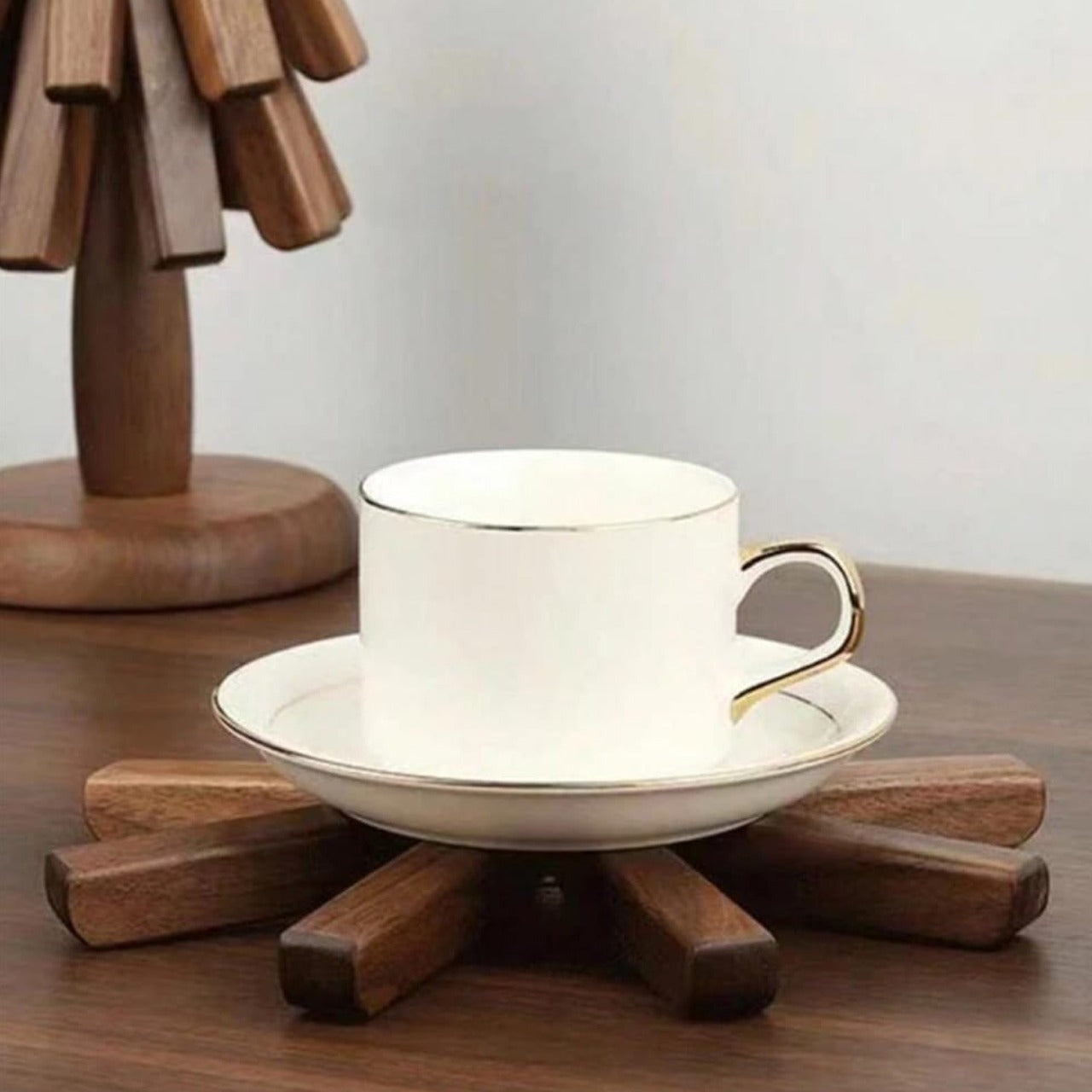 A Coffee Cup is Placed On a Tree Shaped Wooden Dish Mat.