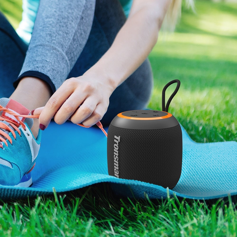 A Person is Playing Tronsmart T7 Mini Outdoor Speaker While Jogging.