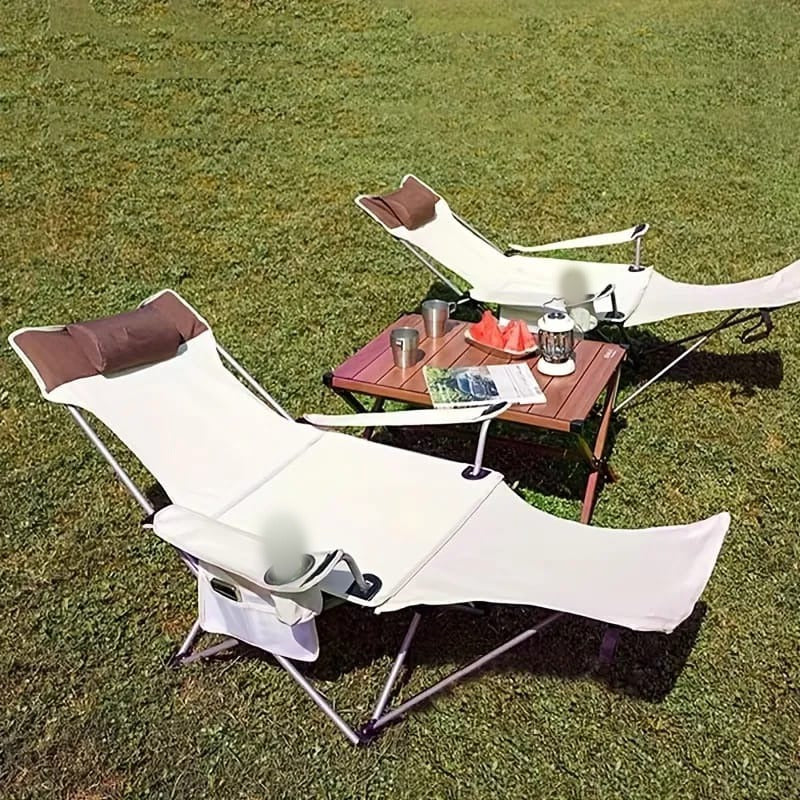 Two Camping Chairs Are Arranged Near Picnic Tabe.